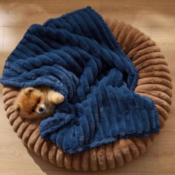 Waterproof dog blanket on floor with dog resting on soft sherpa fleece