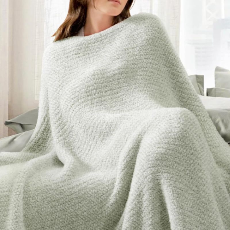 Snuggle Sac Heather Sage Green Throw Blanket – Soft Cozy Knit Throw (50" x 60") | Willow Haven Co woman wrapped in soft sage green throw blanket